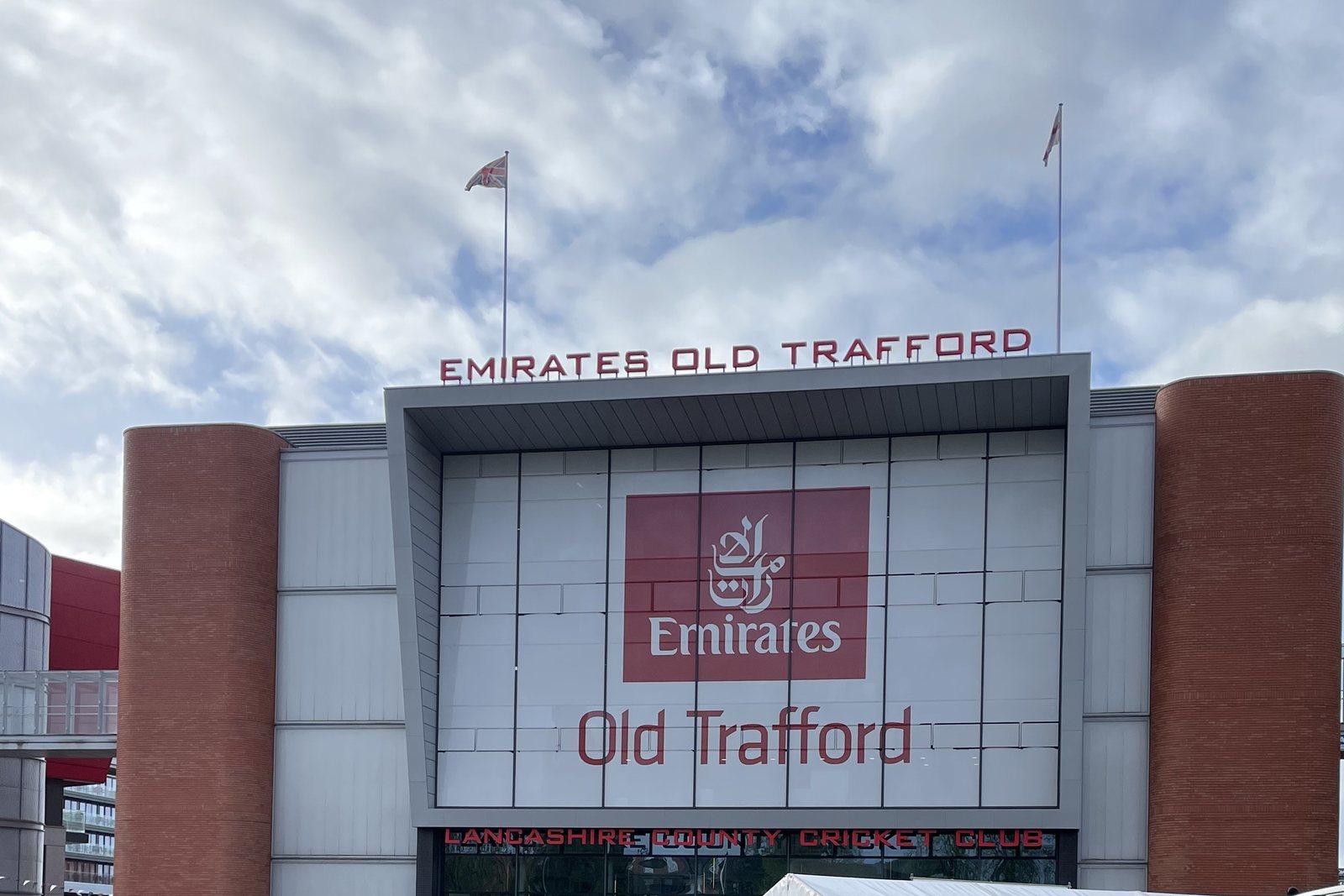 The Pavilion’s entrance facade at Emirates Old Trafford, with its red-brick towers and venue lettering, in April 2024